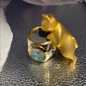 Vintage Elgin gold tone cat clock .